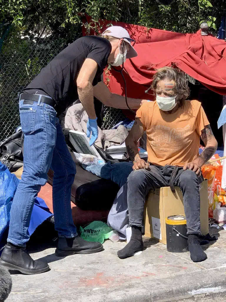 man helps homeless